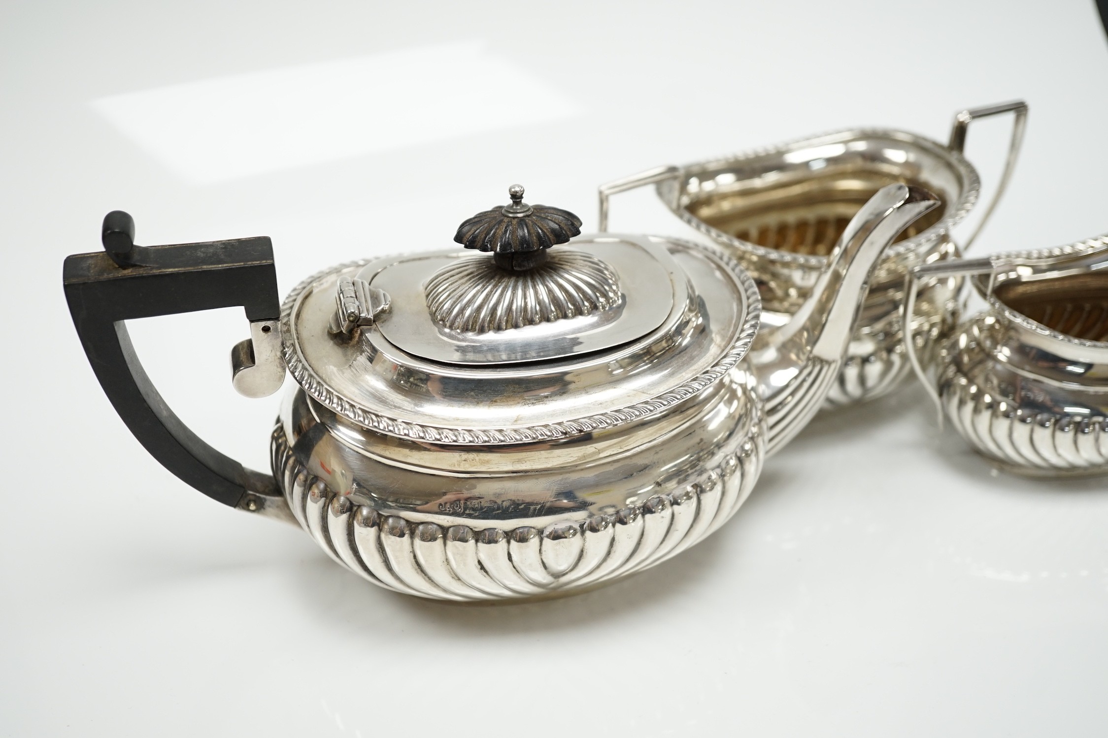 A George V demi fluted silver three piece bachelor's tea set, Jones & Crompton, Birmingham, 1913, gross weight 14.5oz.